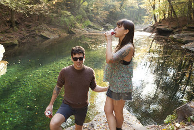 Young couple standing near a river