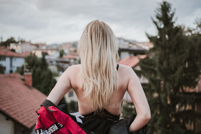 Rear view of woman against sky