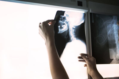 Midsection of person photographing through smart phone