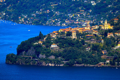 Scenic view of sea by buildings in city