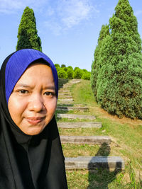 Portrait of woman wearing hijab against trees