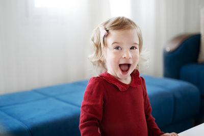 Adorable happy amazed open mouth caucasian blonde baby girl, toddler, infant, smiling, laughing