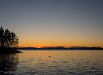 Scenic view of lake against romantic sky at sunset