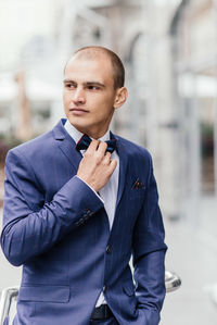 Portrait of young man standing outdoors