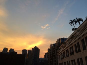 Low angle view of buildings against sky at sunset