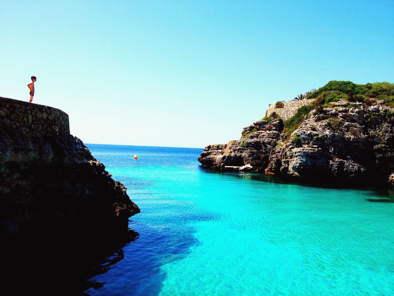 sea, water, clear sky, horizon over water, scenics, tranquil scene, tranquility, rock formation, copy space, blue, beauty in nature, cliff, rock - object, nature, rock, idyllic, beach, shore, coastline, calm