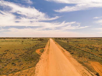 Dirt road along countryside landscape