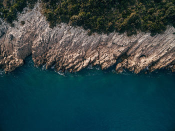 High angle view of rocks on sea shore