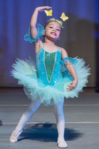 Full length of girl dancing on stage