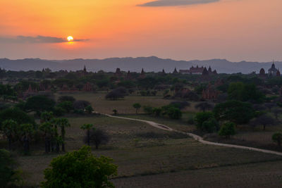 Scenic view of landscape against orange sky