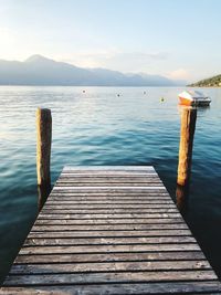 Wooden pier over lake against sky