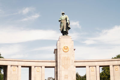 Low angle view of statue against cloudy sky