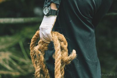 Close-up of man holding rope