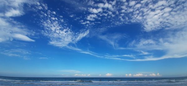 Scenic view of sea against blue sky