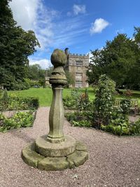 Statue in park against sky