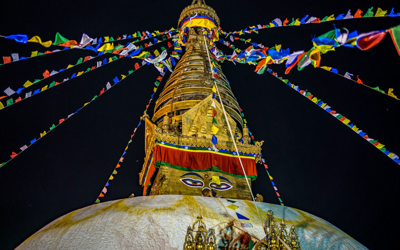 religion, belief, architecture, temple - building, spirituality, decoration, night, travel destinations, tradition, multi colored, built structure, place of worship, no people, flag, celebration, event, history, travel, sky, nature, building, building exterior, outdoors, pagoda, the past, city, illuminated, ancient