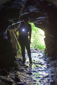 Full length of woman standing in cave