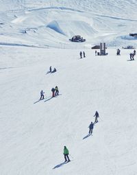 High angle view of people skiing on snowcapped mountain