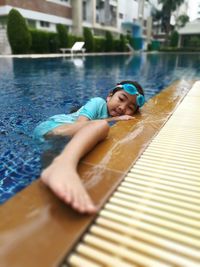 Portrait of happy girl swimming in pool