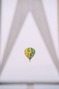 Distant view of hot air balloon flying in sky