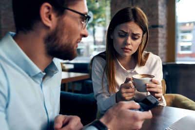 Young couple holding coffee