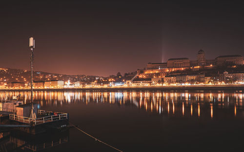 Illuminated buildings in water at night