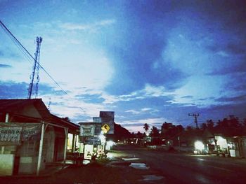 Street amidst buildings in city against sky