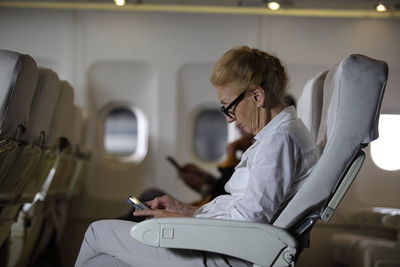 Side view of woman using mobile phone