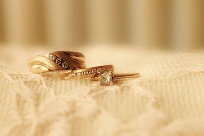 Close-up of wedding rings kept on veil