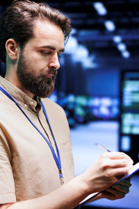 Side view of young man working in office