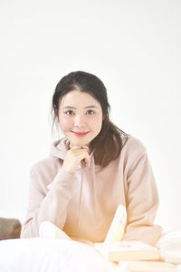 Portrait of young woman sitting at home