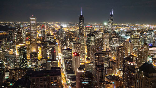 Aerial view of city lit up at night