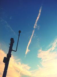 Low angle view of street light against blue sky