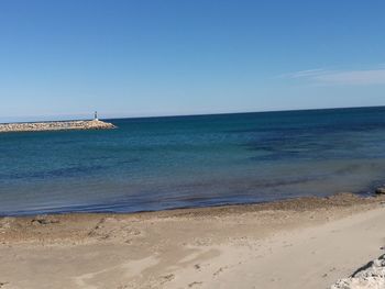 Scenic view of sea against clear blue sky