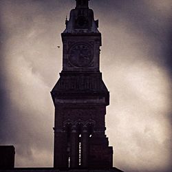 Low angle view of tower against cloudy sky