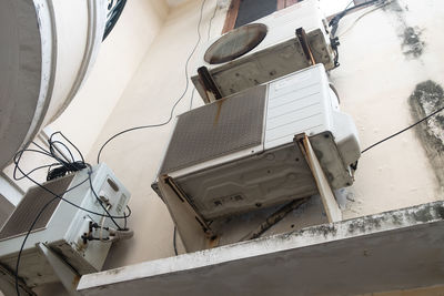 Low angle view of ladder on wall, air conditioner