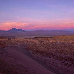 Scenic view of desert against sky during sunset