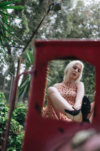 Young woman sitting on miniature train