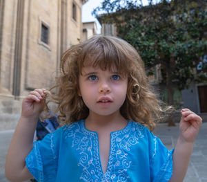 Portrait of young woman standing outdoors