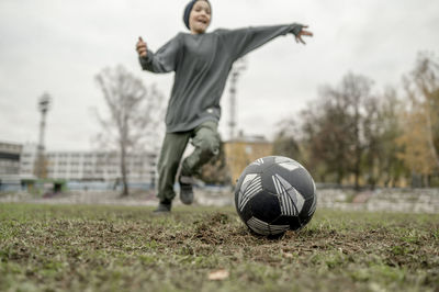 Boy playing soccer at field