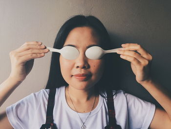 Close-up of woman holding spoons