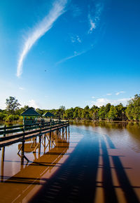 Small pedestrian bridge over lake tahai in palangka raya, central kalimantan, indonesia