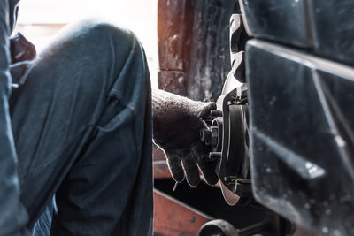 Midsection of man working in workshop