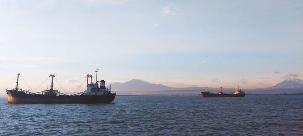 Boats in sea against sky