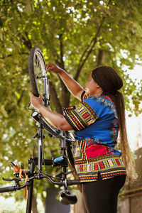 Rear view of woman holding umbrella