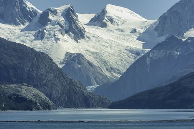 Scenic view of snowcapped mountains by sea