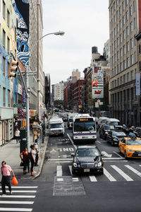 Vehicles on road along buildings