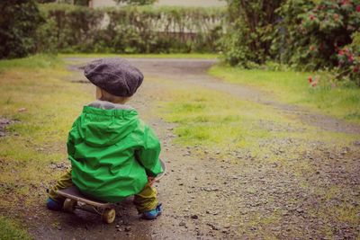 Boy sitting on skateboard 