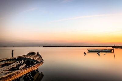 Scenic view of lake against sky during sunset