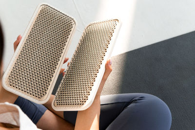 Person holding sadhu boards for nails standing practice, cropped picrure